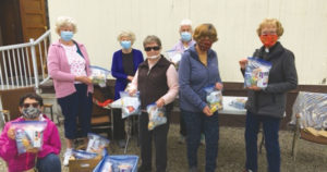 Everyday Christians at St Mary’s, Kelowna, putting together “Blessing Bags” for the homeless. Photograph: Heather Karabelas.